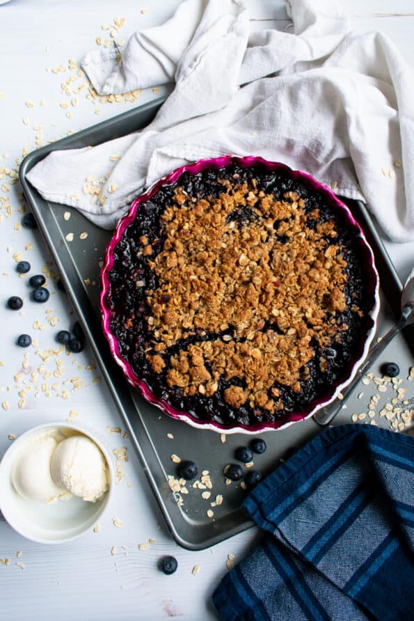 blueberry crumble in pie dish on tray