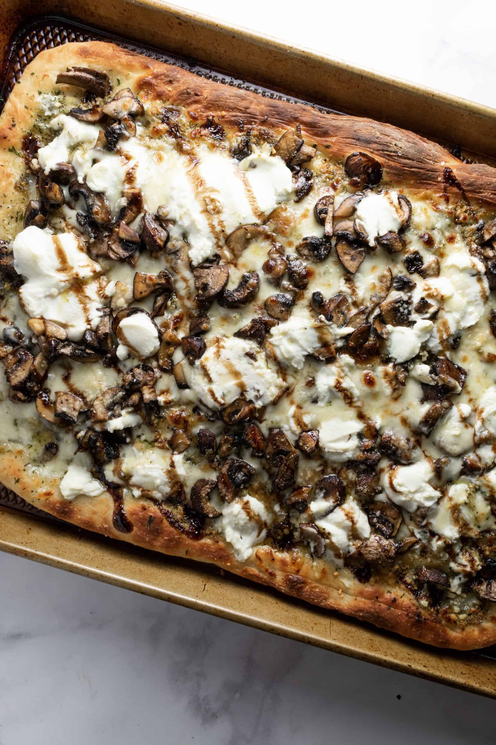 white pizza with mushrooms on tray
