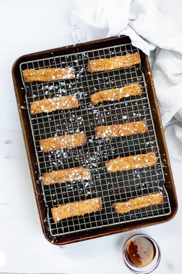 french toast sticks on a baking sheet and white background