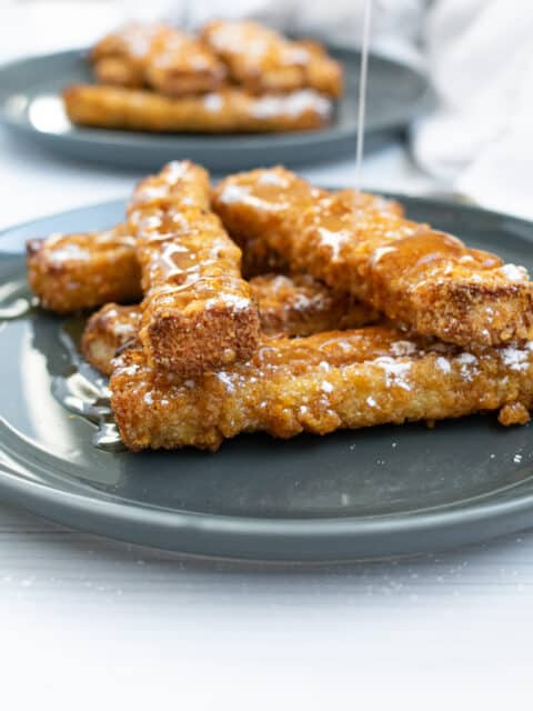 french toast sticks on a gray plate and white background