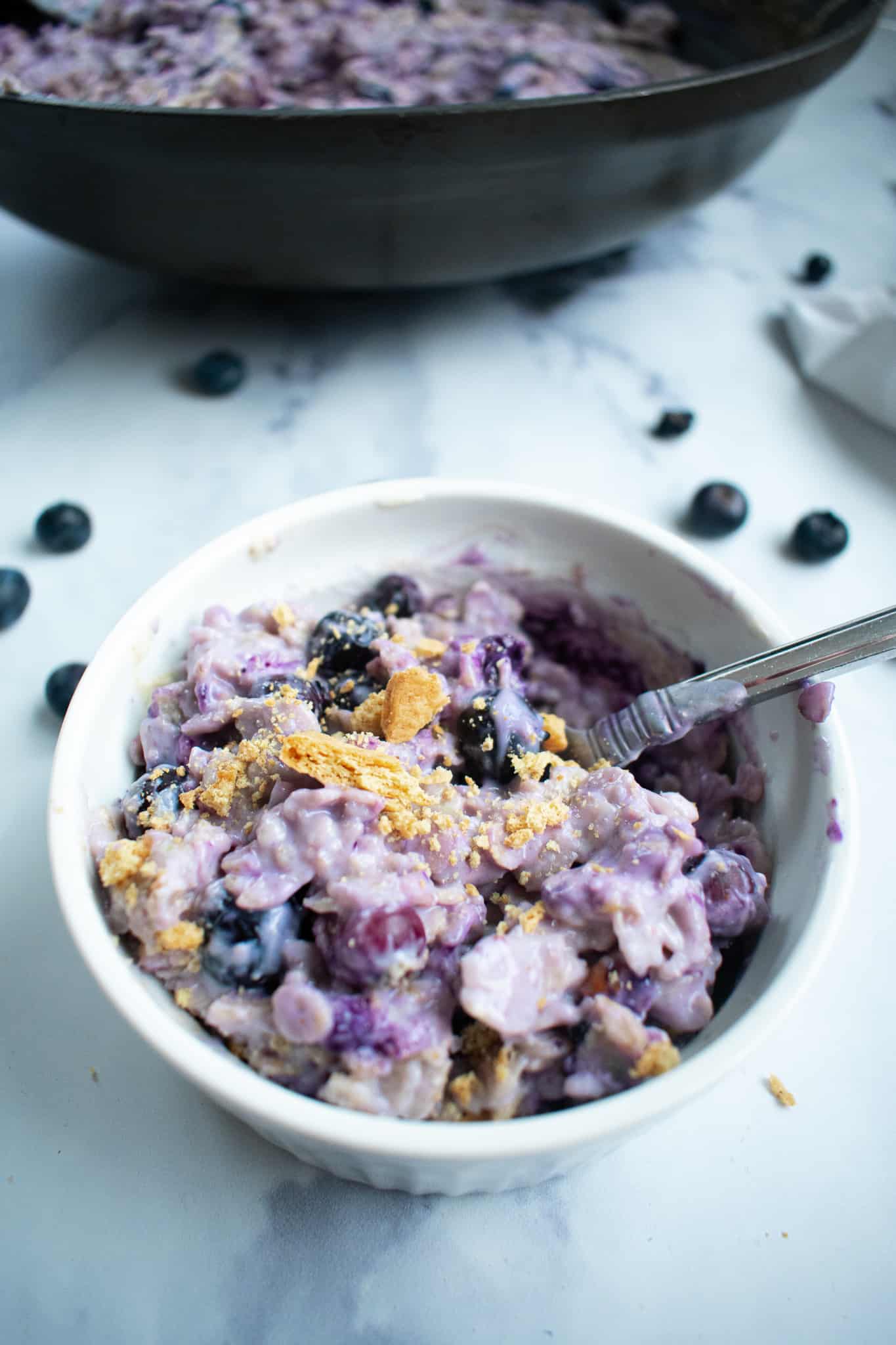 blueberry oatmeal in a bowl with spoon