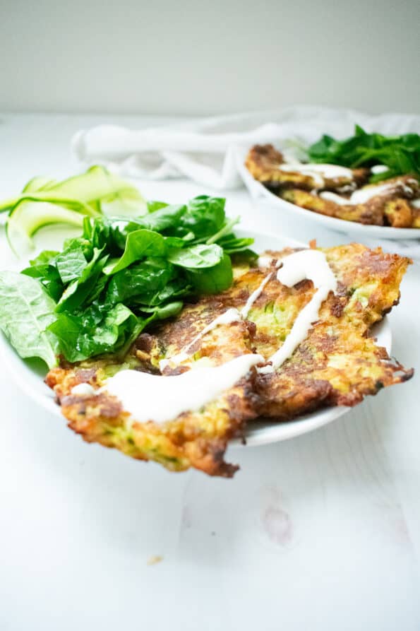 zucchini fritters on white plate