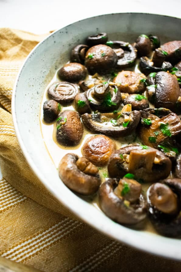 mushrooms in a bowl on a yellow napkin