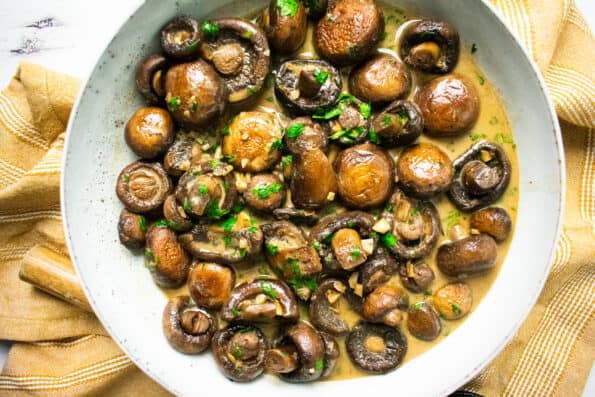 mushrooms in a bowl on a yellow napkin