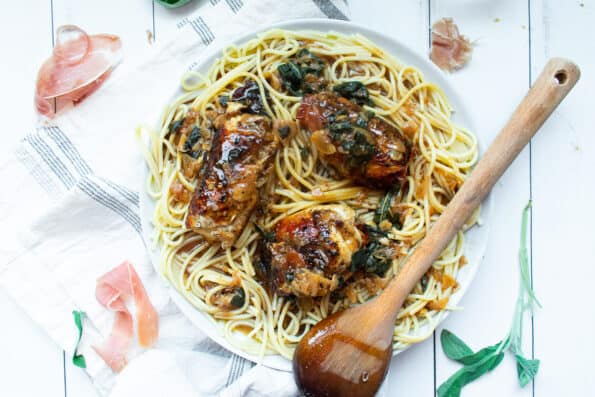 stuffed chicken cutlets on a plate with spaghetti